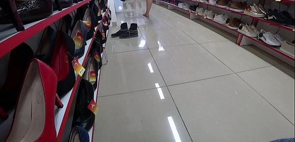  Voyeur and foot fetish in a public place. Beautiful legs in stockings and a juicy ass under a short dress in a shoe store.